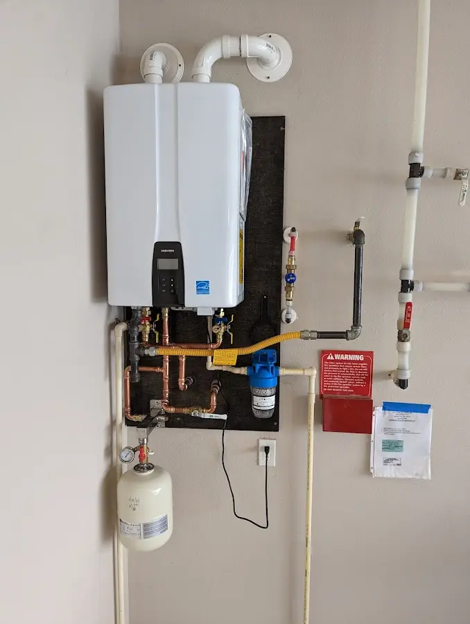 Professional plumber installing copper piping in a Bunkie home